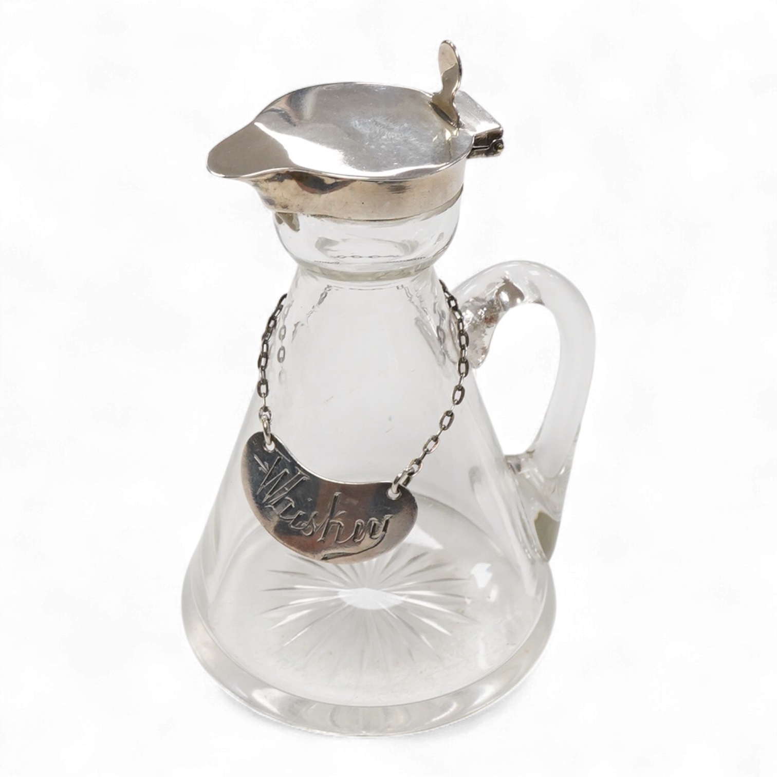An Edwardian silver mounted glass whisky noggin and matching silver 'Whisky' label by Goldsmiths & Silversmiths Co Ltd, London, 1907, height 10.8cm.
